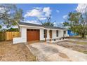 Charming single story home with a new gray roof, red door, and a well-maintained front yard at 8930 94Th Ave, Seminole, FL 33777