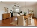 Open concept dining and kitchen area with hardwood floors, a ceiling fan and modern lighting at 9811 Memorial Hwy, Tampa, FL 33615