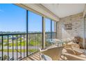 Enclosed balcony with seating overlooking waterfront and city views at 10355 Paradise Blvd # 614, Treasure Island, FL 33706