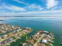 Beautiful aerial shot showcasing a waterfront property with private boat dock and stunning views of the bay at 123 12Th E St, Tierra Verde, FL 33715