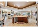 Open kitchen with granite countertops and stainless steel appliances flowing into the living and dining areas at 123 12Th E St, Tierra Verde, FL 33715