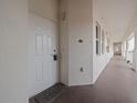 Inviting unit entrance featuring a white front door and welcome mat, promoting a cozy and welcoming space at 17735 Gulf Blvd # 204, Redington Shores, FL 33708