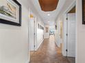 Bright hallway showcasing neutral walls, tile flooring, and views into the living area promoting a seamless flow at 17735 Gulf Blvd # 204, Redington Shores, FL 33708