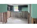 Kitchen featuring dark cabinets, a window, and space for appliances at 1774 Michigan Ne Ave, St Petersburg, FL 33703