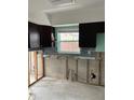 Kitchen featuring dark cabinets, a window, and space for appliances at 1774 Michigan Ne Ave, St Petersburg, FL 33703