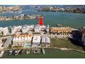 Aerial view showcasing this waterfront condo with a dock on a clear, sunny day at 188 Brightwater Dr # 2, Clearwater Beach, FL 33767