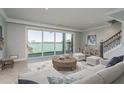 Comfortable living room with water views and a sliding door to the outside at 188 Brightwater Dr # 2, Clearwater Beach, FL 33767