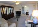 Carpeted living room with a ceiling fan, modern furniture, and a glimpse into the kitchen at 1950 59Th N Ave # 212, St Petersburg, FL 33714
