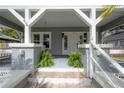Close up of the charming front porch with brick steps and a swing at 311 W Chelsea St, Tampa, FL 33603