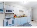 Bright kitchen with white cabinets and appliances at 4215 E Bay Dr # 1702F, Clearwater, FL 33764