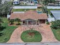 Aerial view showcasing a home with a well-manicured lawn, pool, and brick paved circular driveway at 4581 21St N Ave, St Petersburg, FL 33713