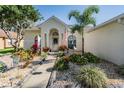 Inviting front entrance with a welcoming walkway, lush landscaping, and decorative stone at 4613 Portobello Cir, Valrico, FL 33596