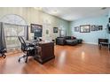 Bright and airy living room with wood floors, large windows, and a comfortable seating area at 4613 Portobello Cir, Valrico, FL 33596