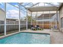 Inviting screened-in pool area with lounge chairs for relaxing and enjoying the outdoors at 4710 69Th E Ct, Palmetto, FL 34221