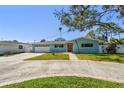 Charming single-story home features a well-manicured lawn and a classic light blue exterior at 5050 Venetian Ne Blvd, St Petersburg, FL 33703