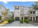 Charming townhome featuring a well-manicured lawn, attached garage, and welcoming front entrance, perfect for comfortable living at 520 Wheaton Trent Pl, Tampa, FL 33619