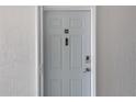 Unit 308 featuring a front door equipped with a smart doorbell and keypad entry system at 5722 Biscayne Ct # 308, New Port Richey, FL 34652