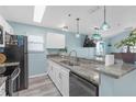 Charming kitchen features granite countertops, modern appliances, and bright lighting at 5722 Biscayne Ct # 308, New Port Richey, FL 34652