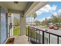View from porch featuring a staircase, metal railing and a parking lot with mature trees at 7224 E Bank Dr # 206, Tampa, FL 33617