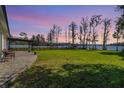 Expansive backyard with a paver patio and lush lawn overlooking a serene waterfront setting at 7730 N Mobley Rd, Odessa, FL 33556