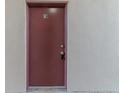 A close up of the red front door with the number sixteen on top, and a peephole in the center at 8640 Tahoe Ct # 16, Tampa, FL 33614