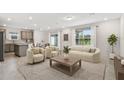 Bright living room features an open concept layout, neutral decor, and modern furnishings at 10410 Cross River Trl, Parrish, FL 34219