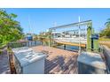 Well-maintained boat dock with boat lift, wooden deck, and canal access for boating enthusiasts at 10627 Hatteras Dr, Tampa, FL 33615