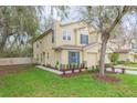 Charming two-story townhome with a well-manicured lawn and attached one-car garage at 10906 Kensington Park Ave, Riverview, FL 33578