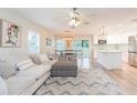 Open-concept living space featuring modern decor, natural light, and seamless flow into the dining area at 10906 Kensington Park Ave, Riverview, FL 33578