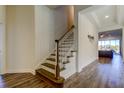 View of the staircase, foyer and hardwood floors and a glimpse of an open concept living space at 11257 Egeria Dr, Odessa, FL 33556