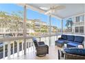 Enclosed lanai with a ceiling fan and comfortable seating overlooking a view of the community at 139 Bluff View Dr # 105, Belleair Bluffs, FL 33770