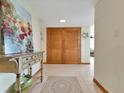 Welcoming entryway with tile flooring, decor, and double doors, enhanced by a vibrant art piece at 1400 Gulf Blvd # 204, Clearwater Beach, FL 33767
