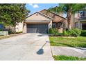 Charming home with a large driveway, complemented by palm trees and well-manicured landscaping at 18855 Hampstead Heath Ct, Land O Lakes, FL 34638