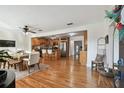 Expansive open-concept living space featuring hardwood floors, dining area, and seamless access to the kitchen at 308 S Arrawana Ave, Tampa, FL 33609