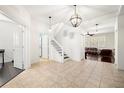 Bright foyer with tile flooring, a staircase, and views into the living room at 5909 Canton S St, St Petersburg, FL 33712