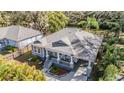 Charming gray home with a cozy front porch, carport, and manicured landscaping at 6911 N 19Th St, Tampa, FL 33610