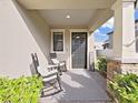 Cozy front porch with rocking chairs, a decorative rug, and attractive landscaping at 943 Terra Vista St, Brandon, FL 33511
