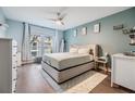 Cozy bedroom with ample natural light, ceiling fan, and hardwood floors at 9481 Highland Oak Dr # 706, Tampa, FL 33647