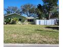 Well-kept home with a green lawn and tidy landscaping at 113 Michigan Blvd, Dunedin, FL 34698