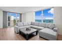 Bright living room featuring water views, a comfortable sectional sofa, and modern accents at 1430 Gulf Blvd # 603, Clearwater Beach, FL 33767