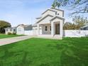 Inviting two-story home with a neatly manicured lawn, cozy porch, and an attached garage at 1753 25Th N Ave, St Petersburg, FL 33713