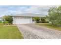 Charming home with a two-car garage, brick driveway, and well-maintained landscaping at 1816 N Pebble Beach Blvd, Sun City Center, FL 33573
