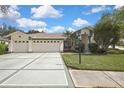 Attractive single-story home with a three-car garage, well-kept lawn, and pleasing curb appeal at 18951 Grand Club Dr, Hudson, FL 34667