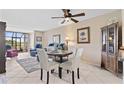 Cozy dining area with golf course view and white chairs in a naturally lit space at 2073 Skimmer W Ct # 211, Clearwater, FL 33762