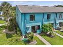 Aerial view of the home's back exterior, showcasing the well-maintained lawn and patio area at 20890 Negril Ct # 5, Lutz, FL 33558