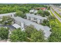 Overhead shot of an apartment building with a metal roof, surrounded by lush greenery and mature trees at 21103 Patio View Ct # 3305, Lutz, FL 33558