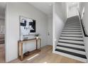 Bright entryway featuring a modern console table, stylish art, and a staircase with contrasting black and white steps at 2205 16Th N St, St Petersburg, FL 33704