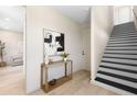 Inviting foyer with sleek hardwood floors, stylish console table, and staircase at 2205 16Th N St, St Petersburg, FL 33704