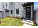 Modern townhome's front entrance features a black door and small landscaped garden at 2205 16Th N St, St Petersburg, FL 33704