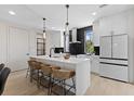 Bright kitchen featuring a large quartz island, sleek cabinetry, and contemporary pendant lighting at 2205 16Th N St, St Petersburg, FL 33704